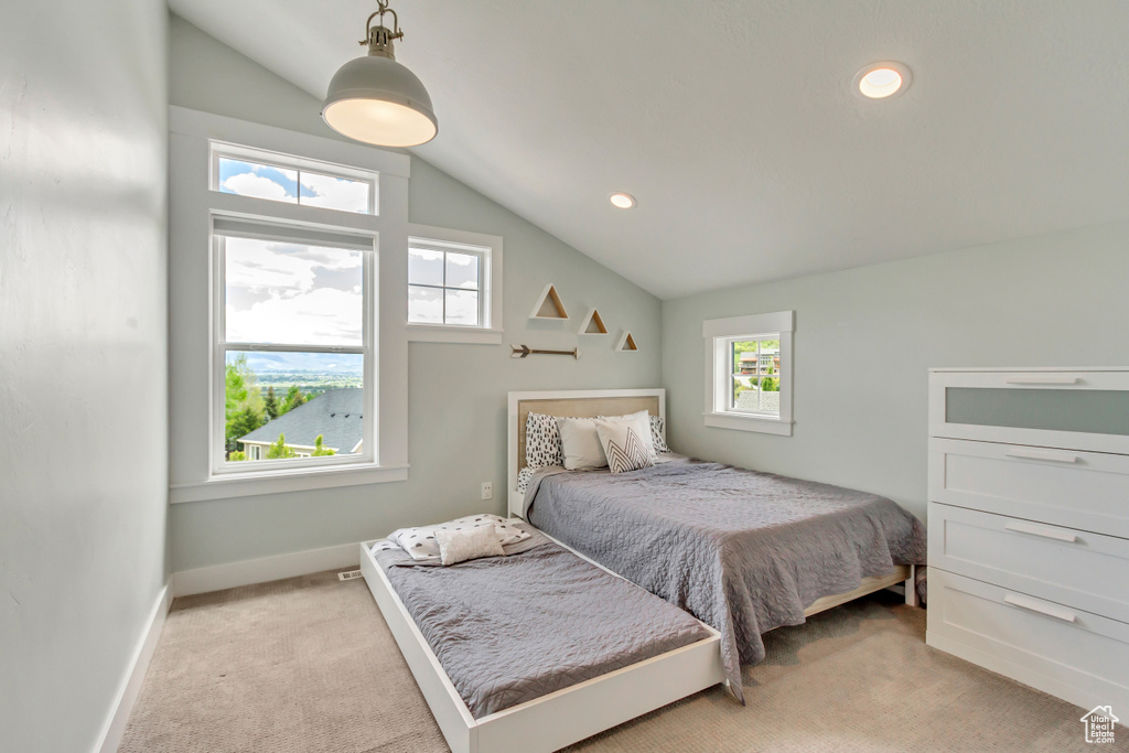 Bedroom with light colored carpet, vaulted ceiling, baseboards, and recessed lighting