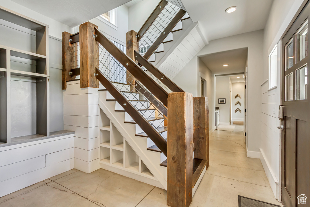 Stairway with recessed lighting and healthy amount of natural light