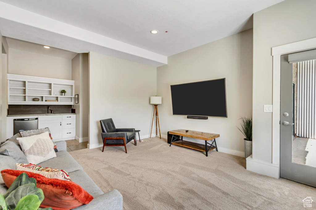 Living area featuring light colored carpet, baseboards, and recessed lighting