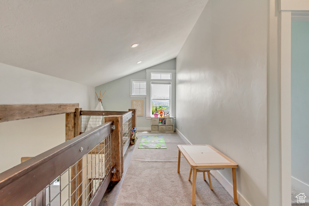 Hallway featuring vaulted ceiling, an upstairs landing, carpet floors, baseboards, and recessed lighting