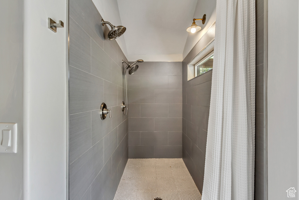Full bath featuring tiled shower