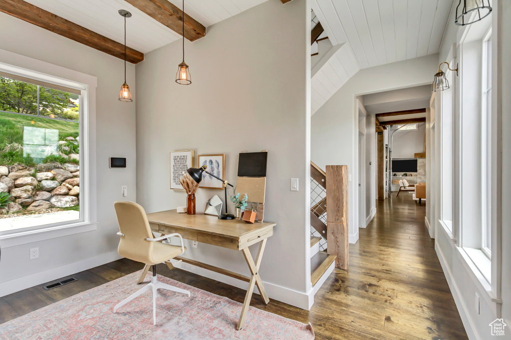 Office featuring beamed ceiling, baseboards, and wood finished floors