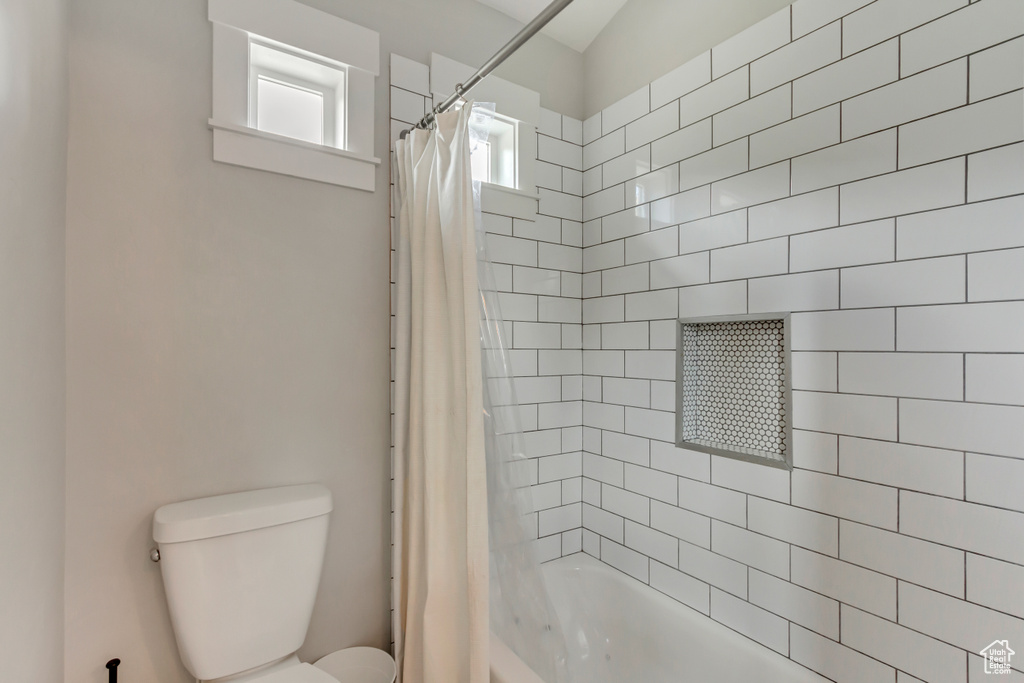 Bathroom with toilet and shower / bath combo