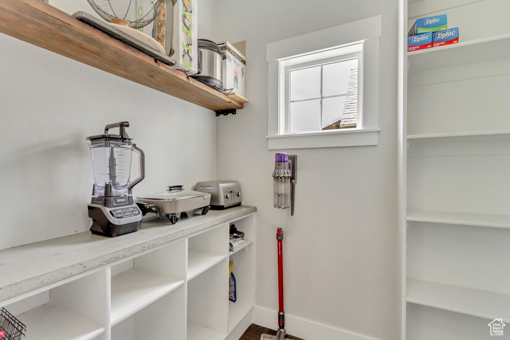 Washroom with baseboards and wood finished floors