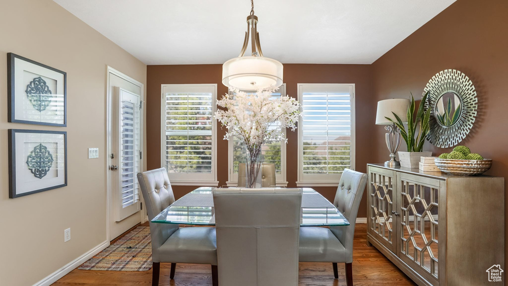 Dining area featuring plenty of natural light, wood finished floors, and baseboards