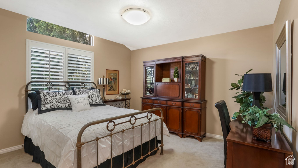 Bedroom with light carpet and baseboards