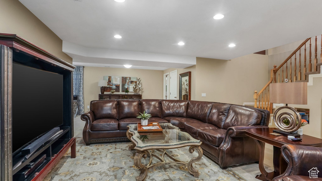 Living area with recessed lighting and stairs