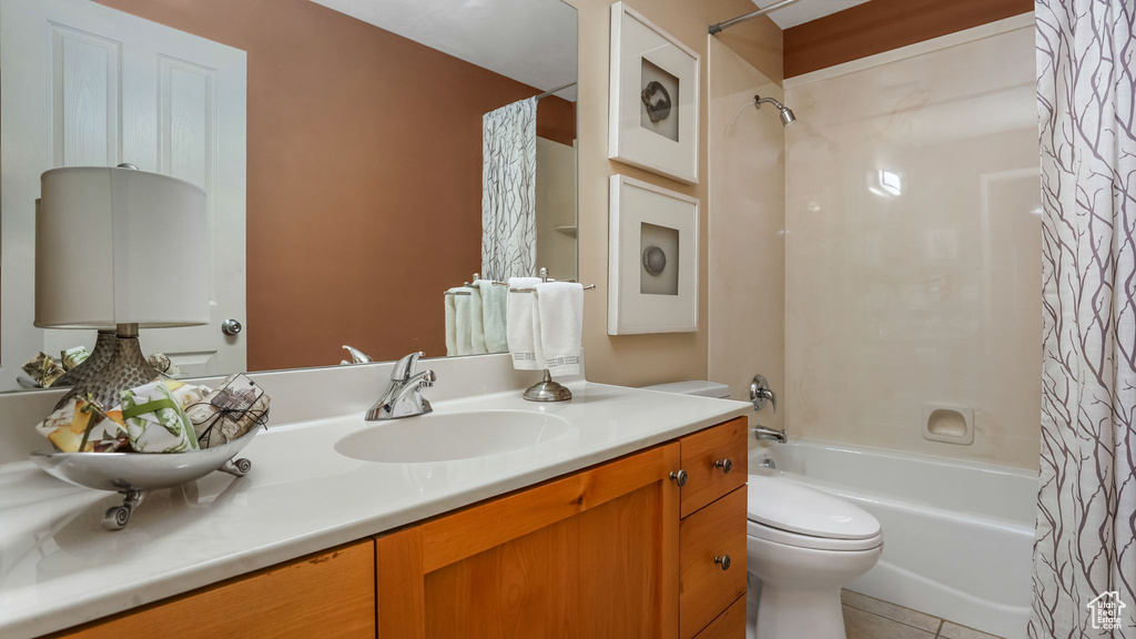 Full bathroom with shower / bath combination with curtain, toilet, vanity, and tile patterned flooring