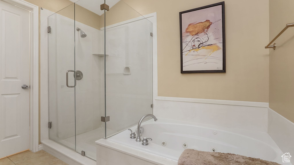Full bath featuring a stall shower, a whirlpool tub, and tile patterned floors
