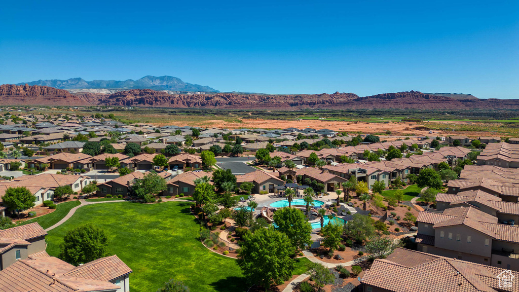 Aerial perspective of suburban area featuring mountains and a pool