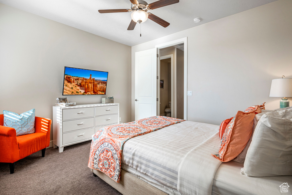 Carpeted bedroom featuring a ceiling fan