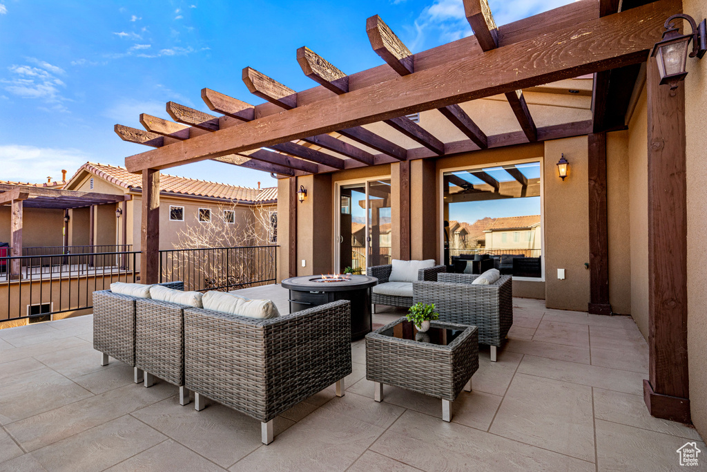 View of patio / terrace featuring an outdoor living space with a fire pit and a pergola