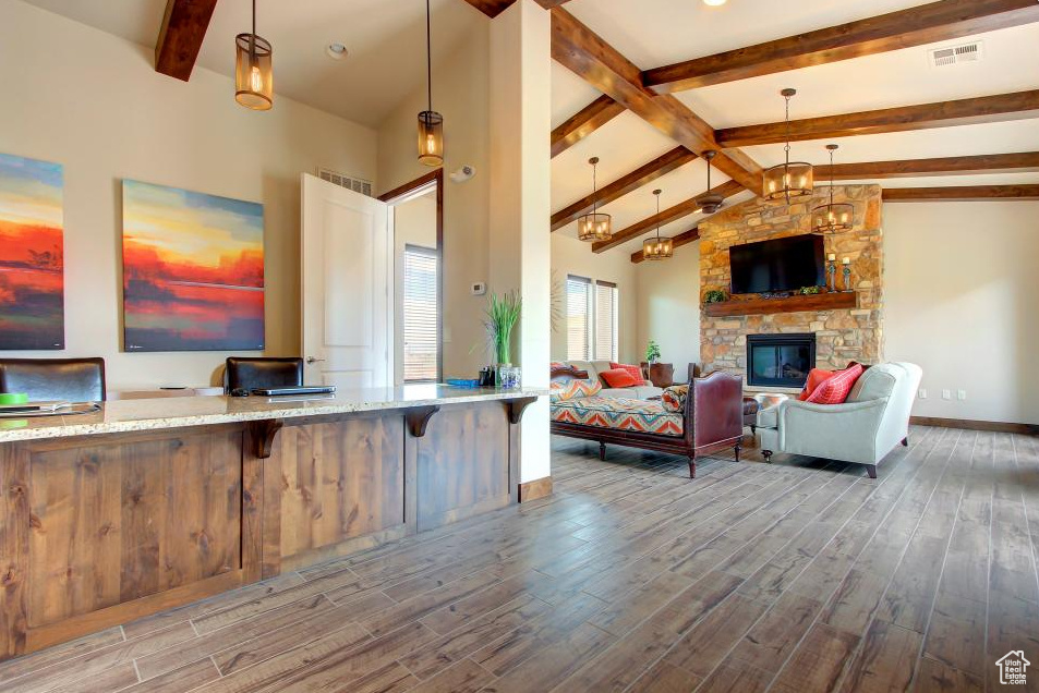 Living area with wood finished floors, a fireplace, and baseboards