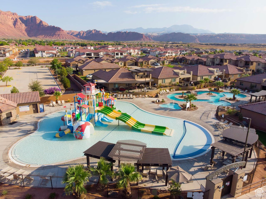 View of swimming pool featuring a water play area, a residential view, and a mountain view