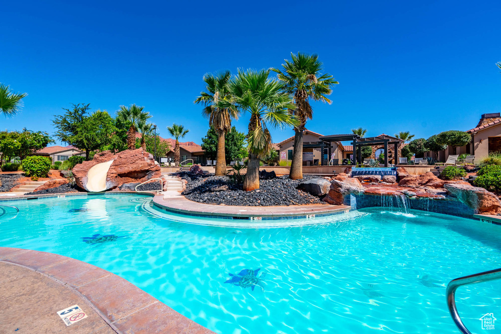 Community pool featuring a pergola