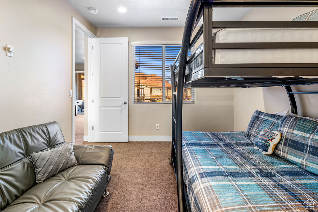 Carpeted bedroom featuring baseboards