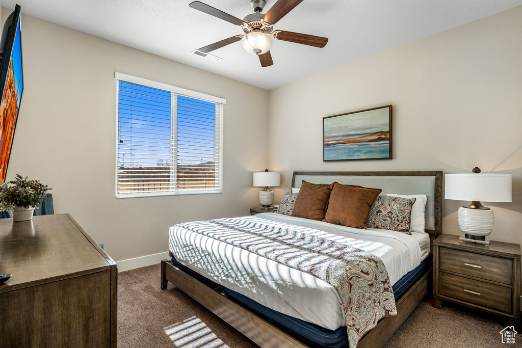 Carpeted bedroom with baseboards and ceiling fan