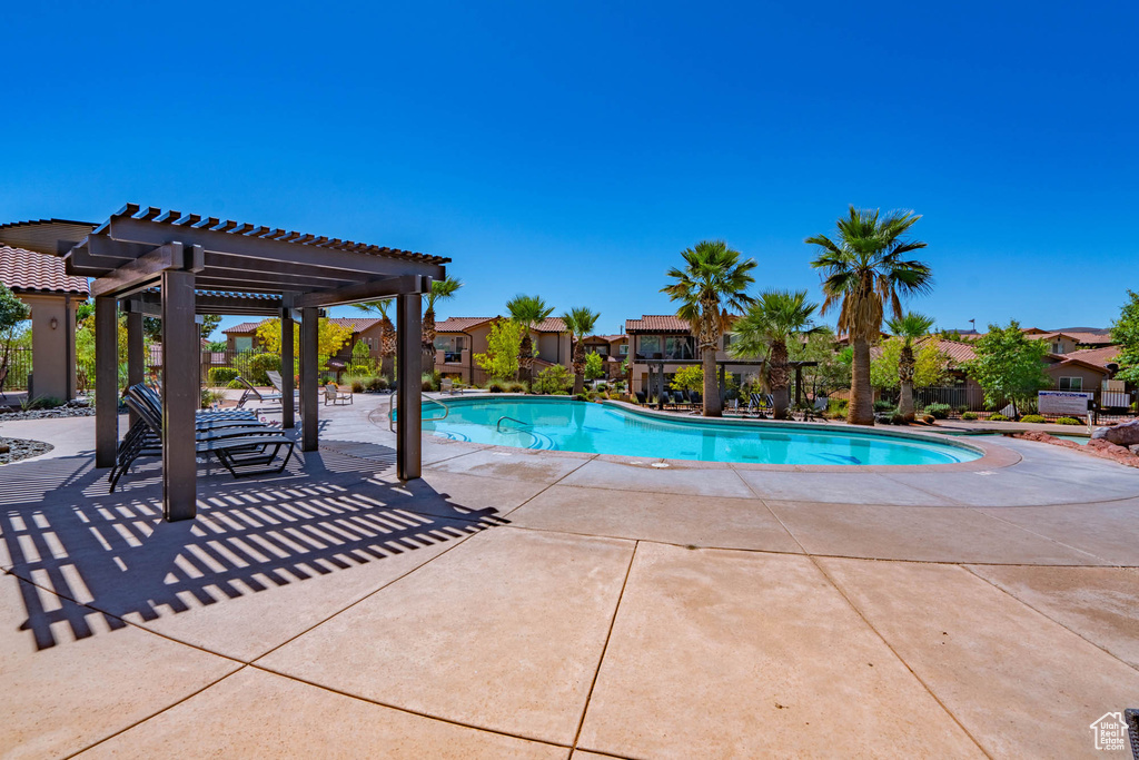 Community pool featuring a pergola and a patio area
