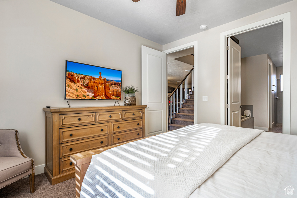 Carpeted bedroom featuring baseboards and a ceiling fan