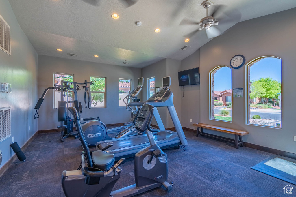 Workout area featuring carpet floors, a ceiling fan, baseboards, recessed lighting, and vaulted ceiling