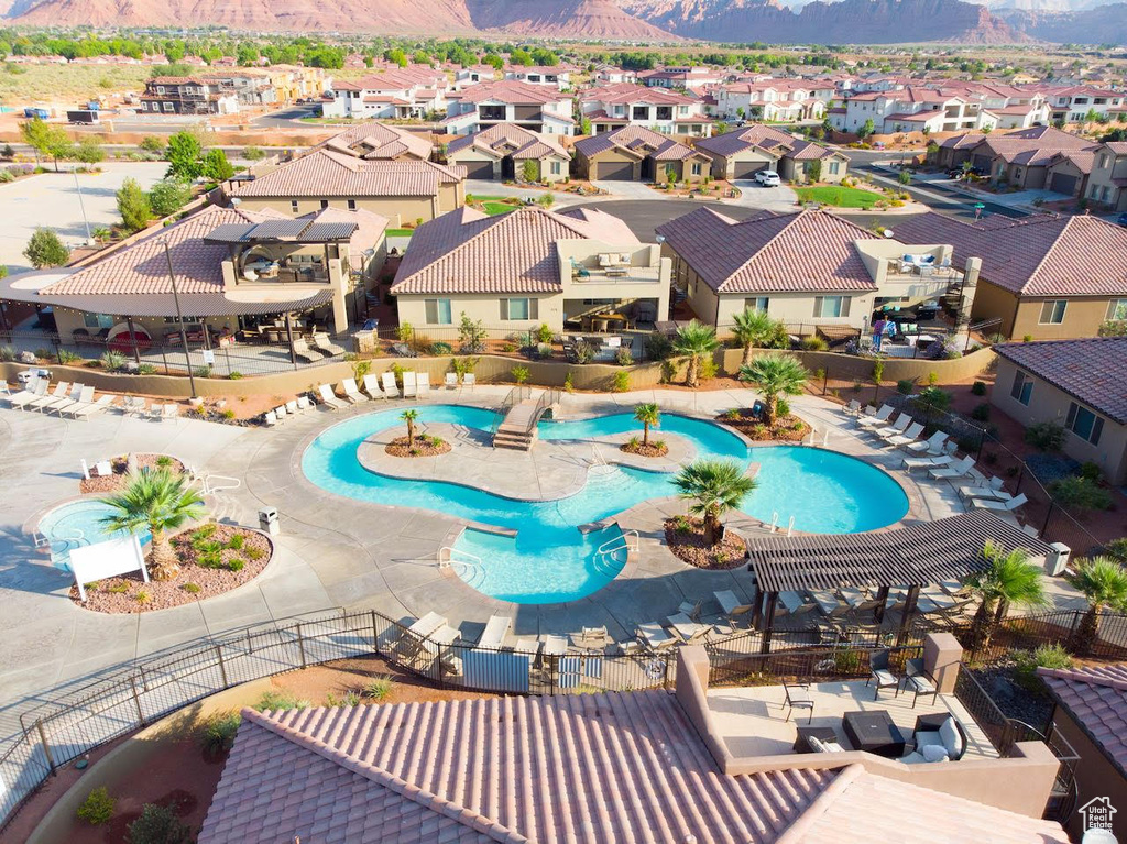 Community pool with a mountain view and a residential view