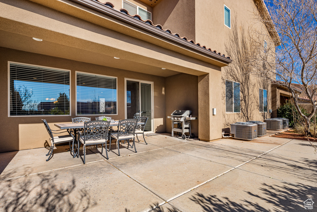 View of patio featuring outdoor dining area, central air condition unit, and area for grilling