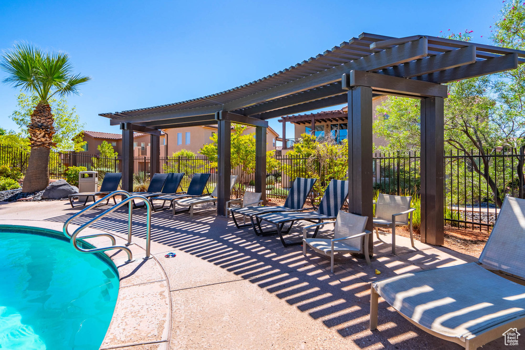 View of pool with a pergola and a patio area