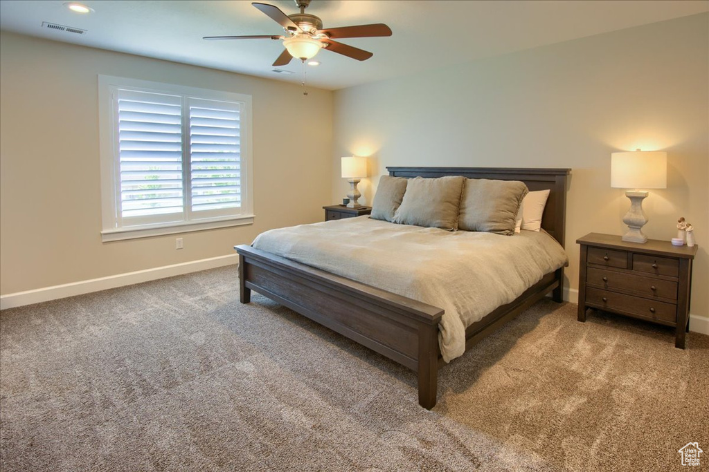 Bedroom featuring carpet flooring, baseboards, and a ceiling fan