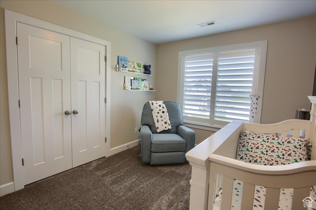 Bedroom with carpet floors, baseboards, and a closet