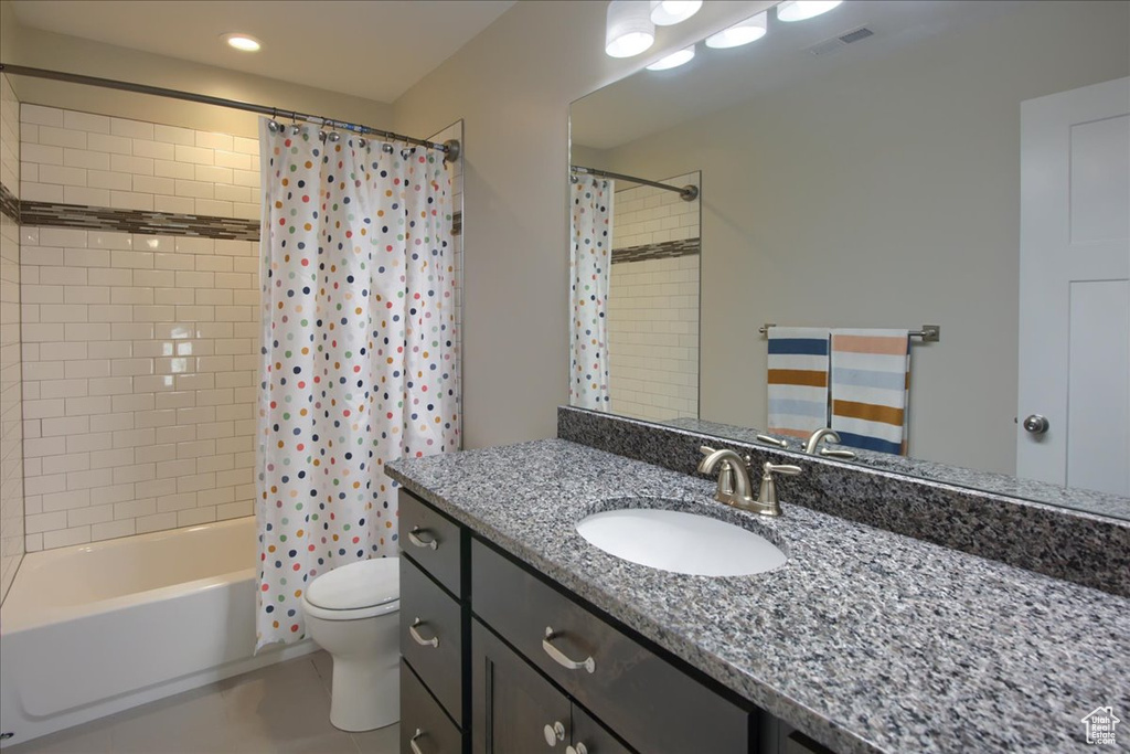 Bathroom with vanity, toilet, shower / tub combo with curtain, recessed lighting, and tile patterned floors
