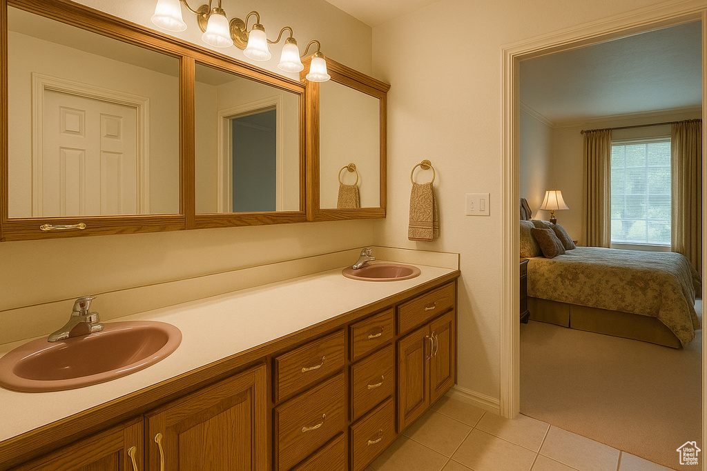 Full bath with double vanity, tile patterned flooring, ensuite bathroom, and baseboards