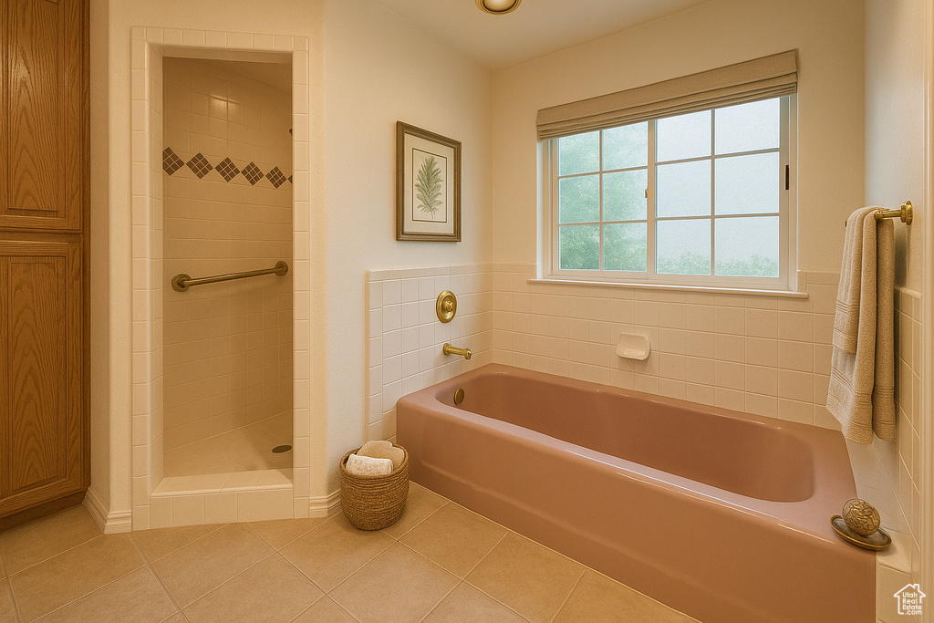 Full bath with tile patterned floors, a bath, and tiled shower