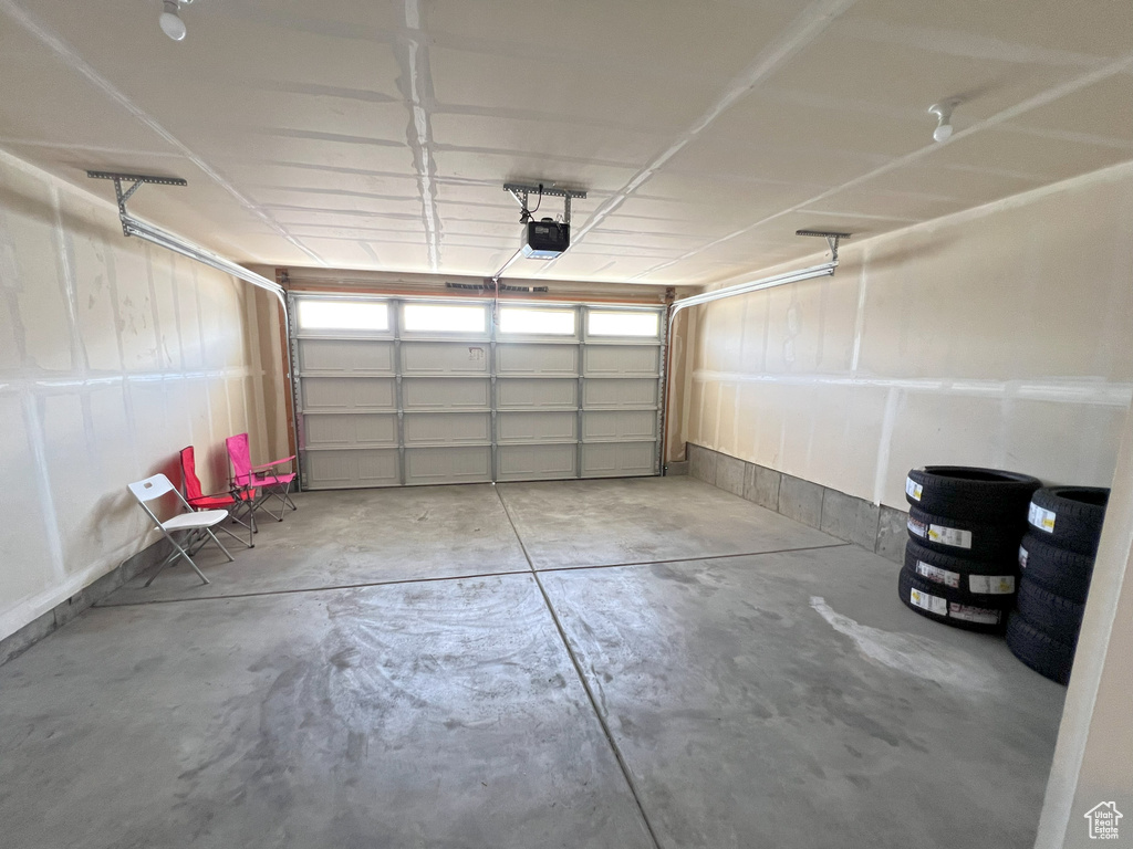 Garage featuring a garage door opener