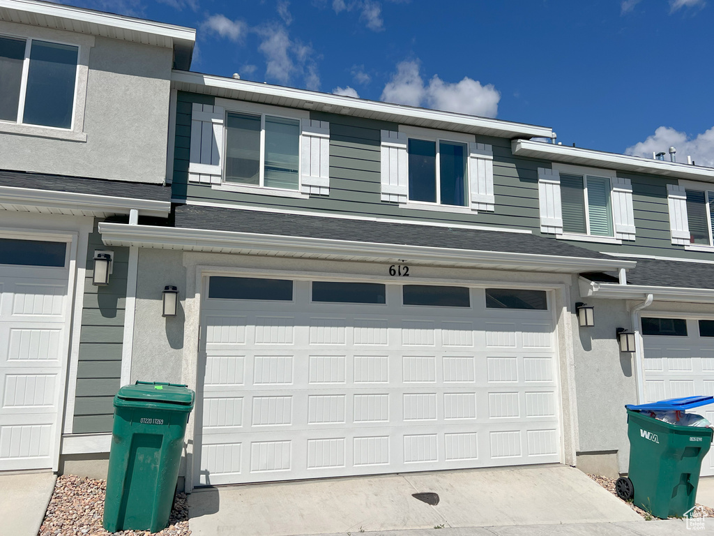Garage featuring concrete driveway