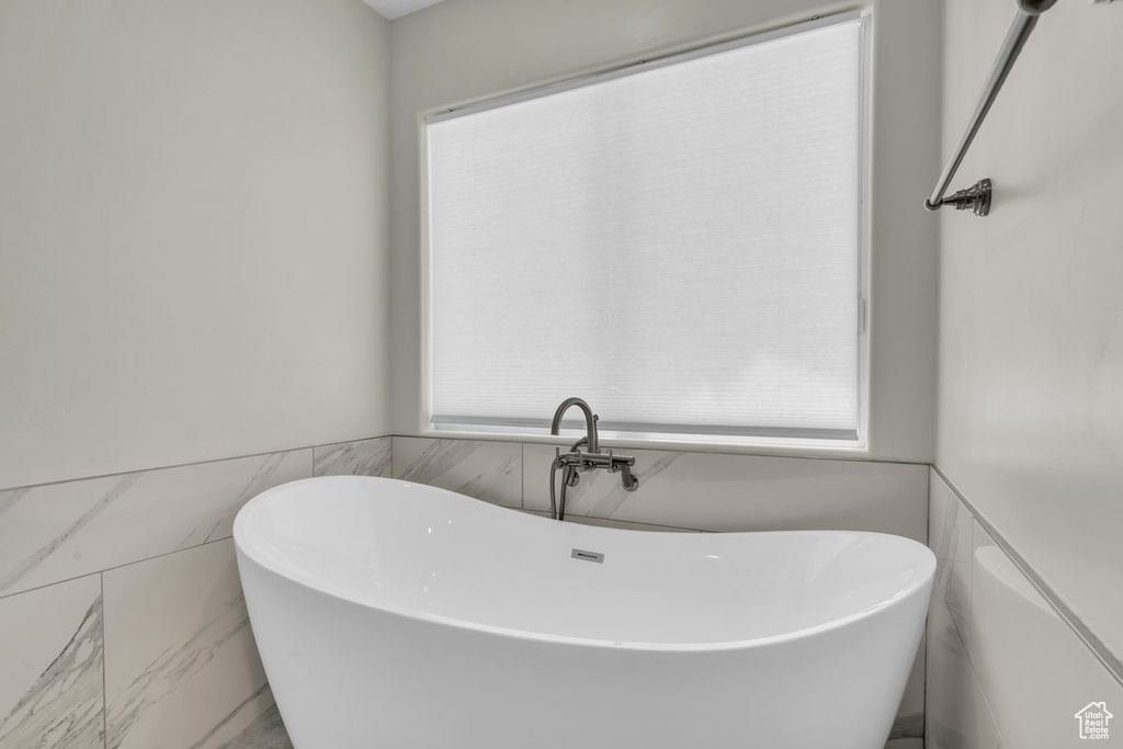 Full bath with a freestanding bath and plenty of natural light