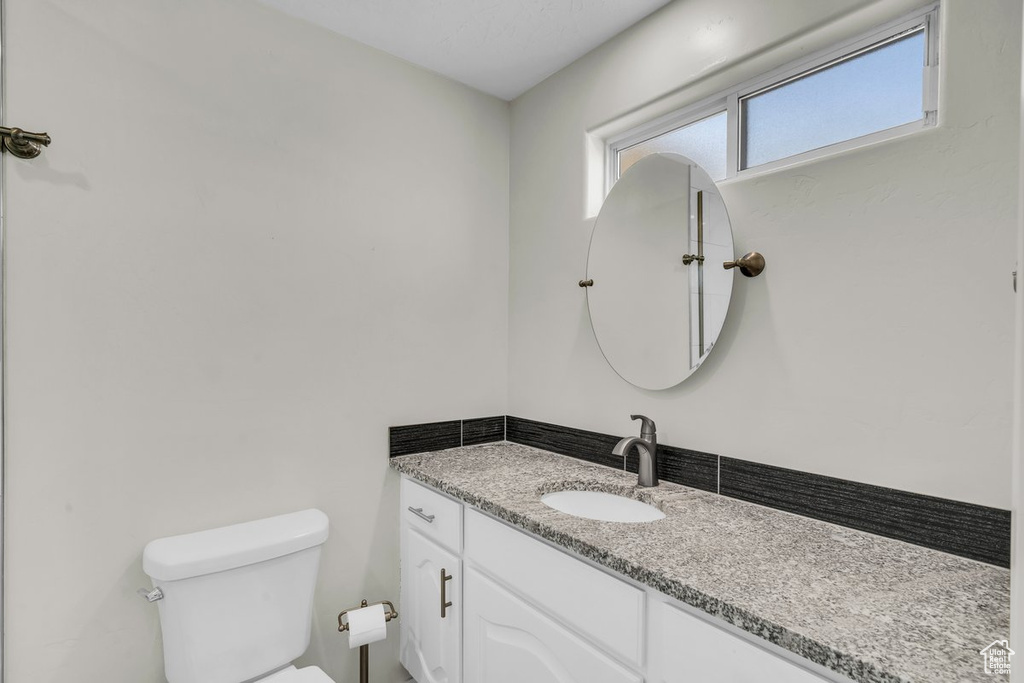 Half bathroom featuring toilet and vanity
