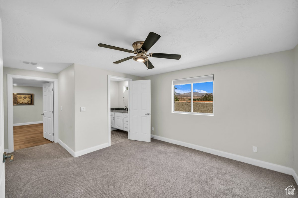 Unfurnished bedroom with carpet, baseboards, and ceiling fan
