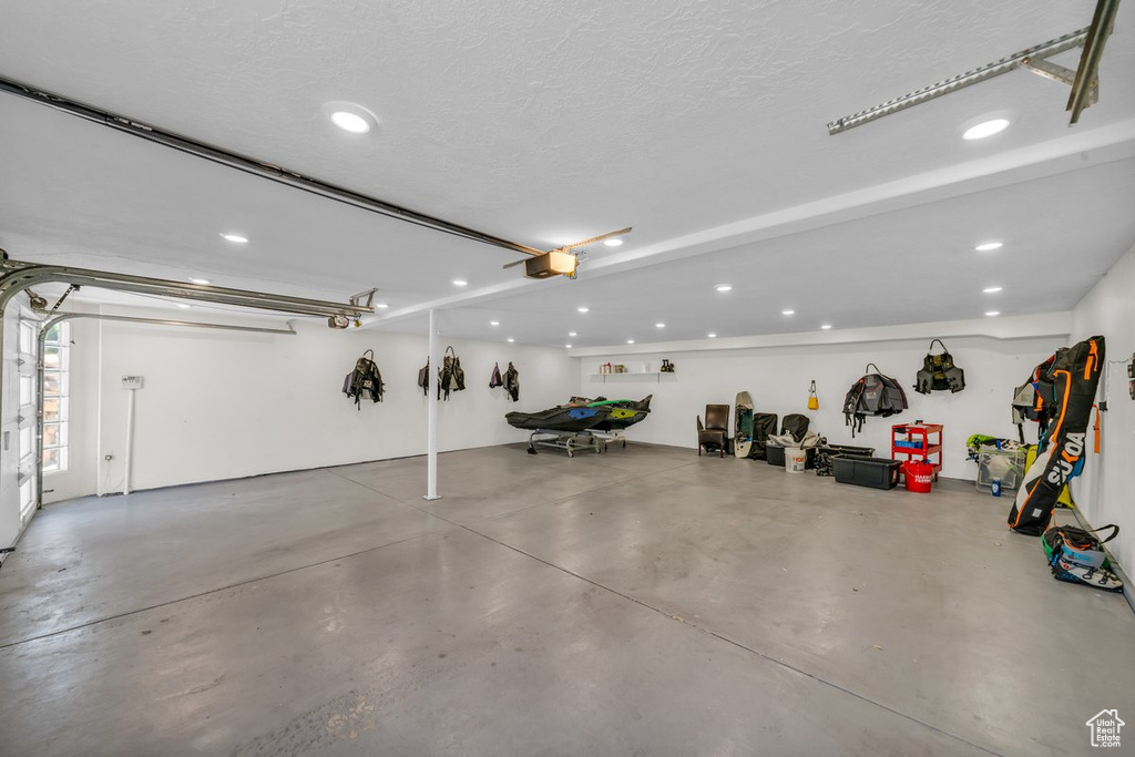Garage featuring a garage door opener and recessed lighting