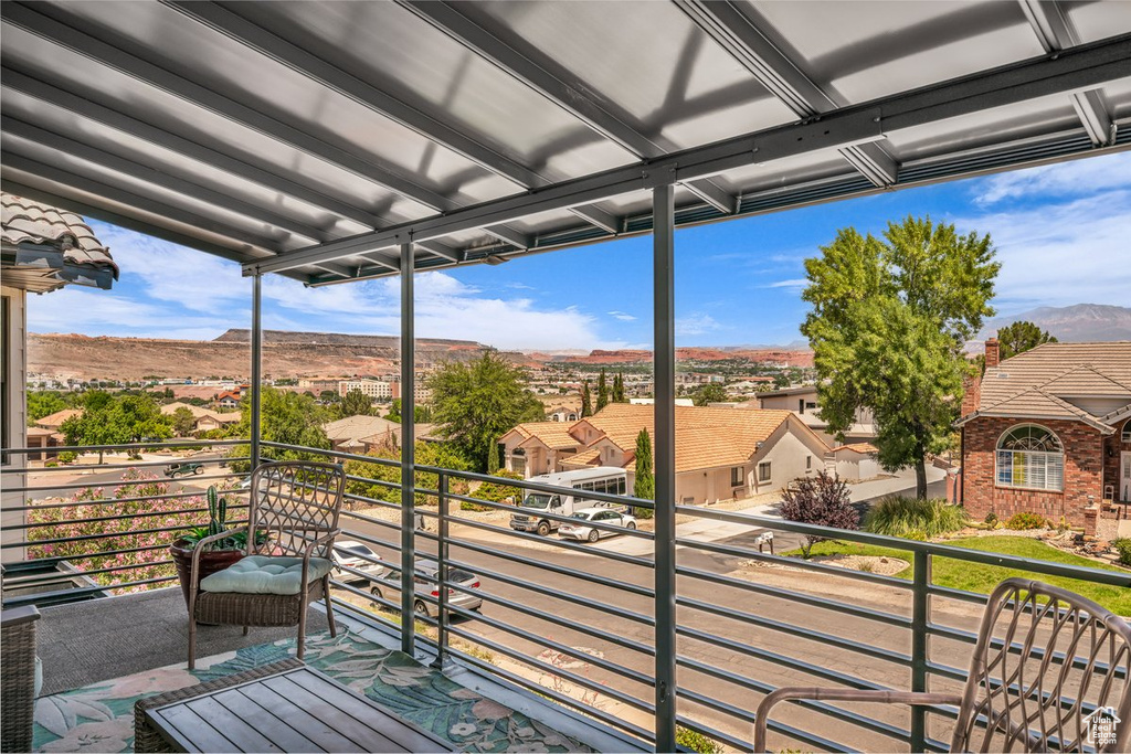 Balcony featuring a residential view and a mountain view
