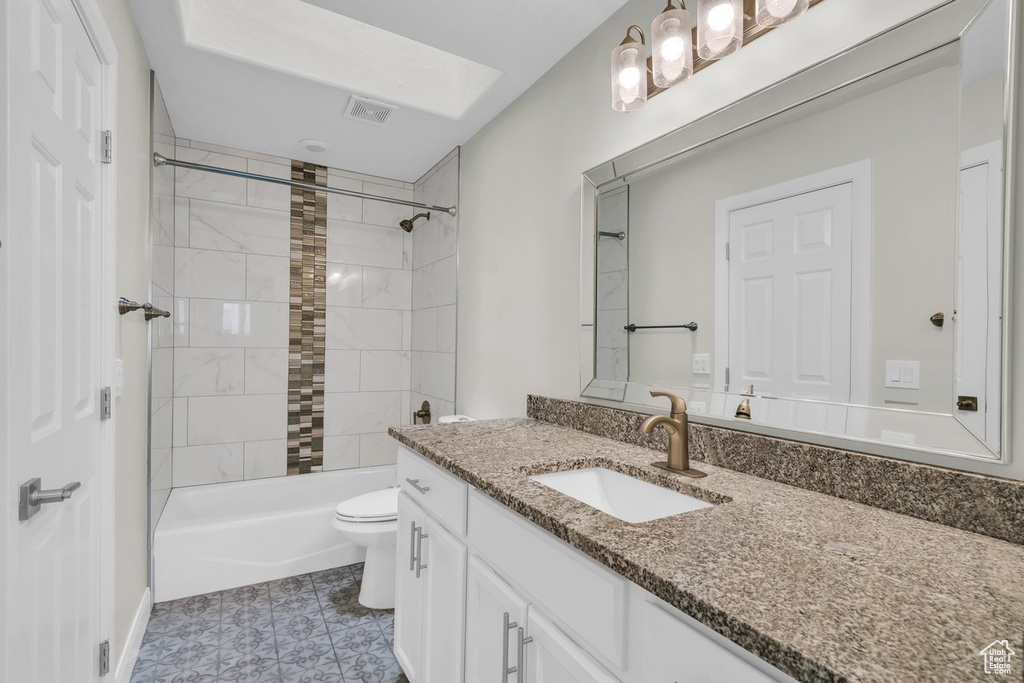 Full bath with vanity, toilet, and shower / washtub combination
