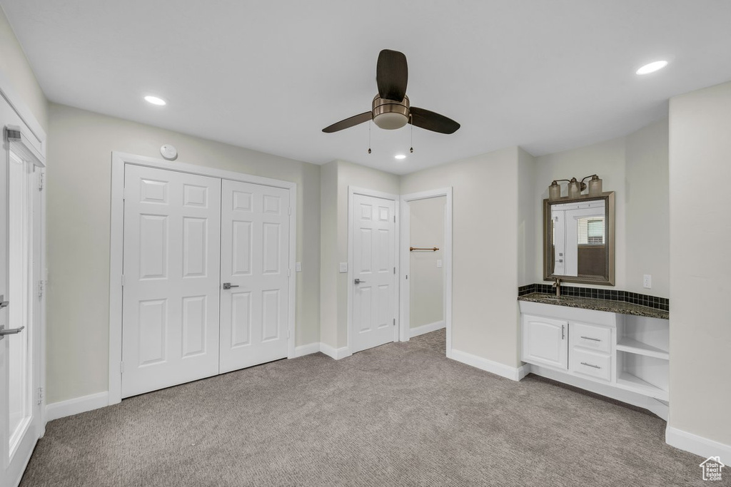Unfurnished bedroom featuring light colored carpet, baseboards, recessed lighting, and ceiling fan