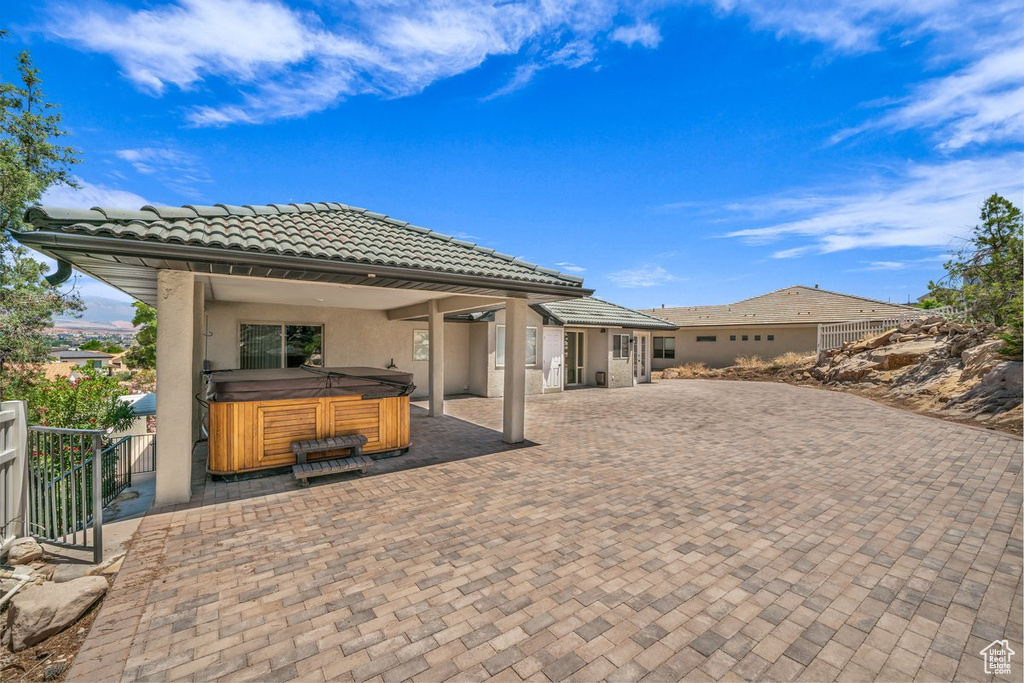 View of patio featuring a hot tub
