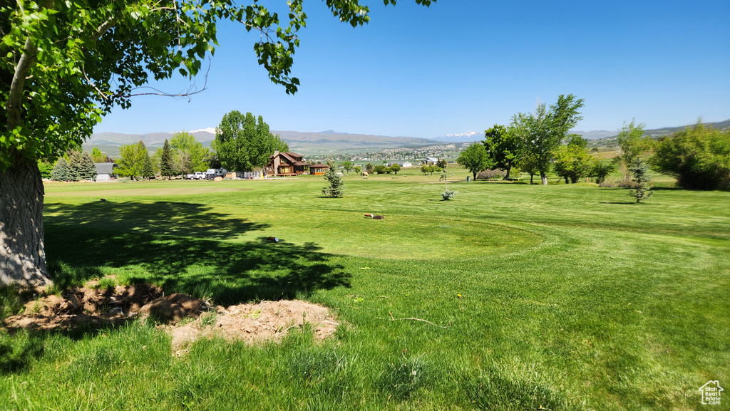 Surrounding community featuring a mountain view and a yard