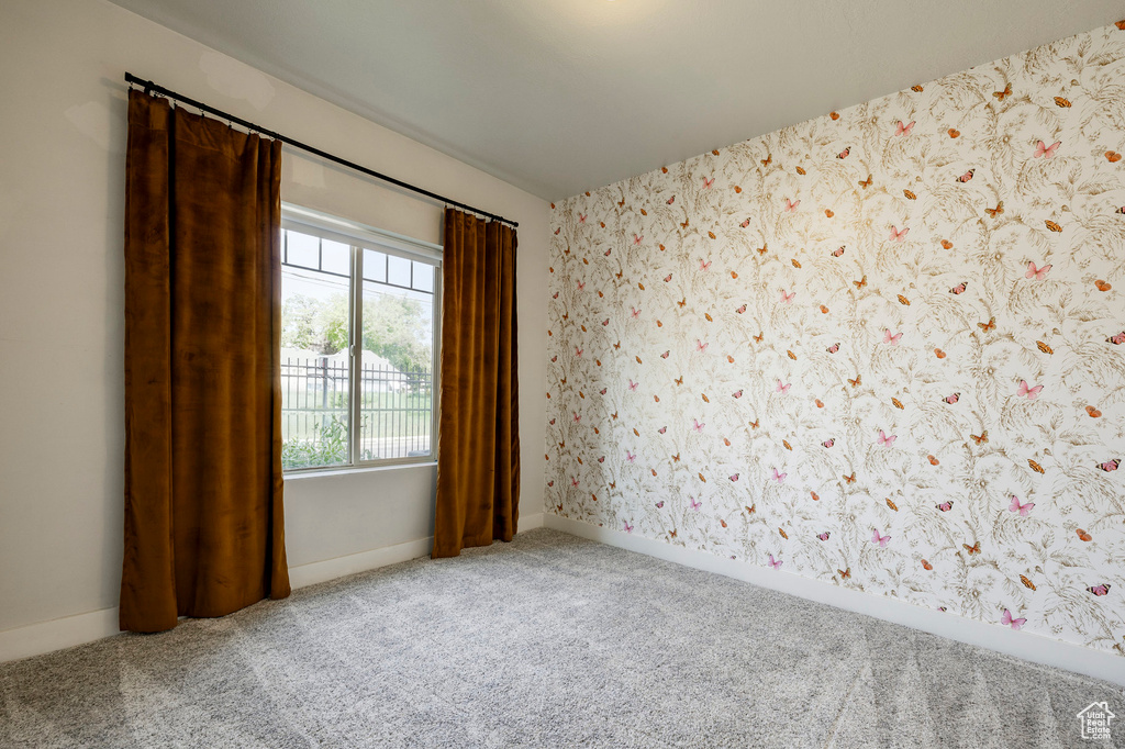 Unfurnished room with carpet and baseboards