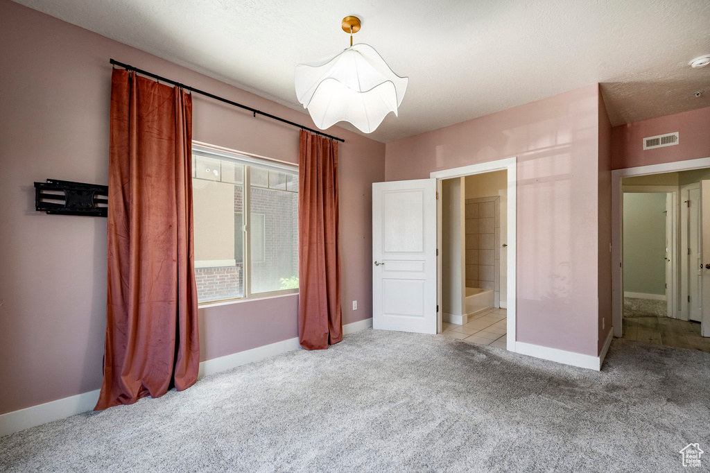 Unfurnished bedroom featuring carpet and baseboards