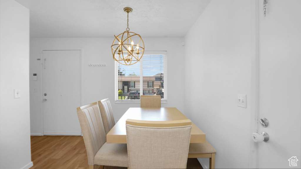 Dining room featuring a chandelier, wood finished floors, and baseboards