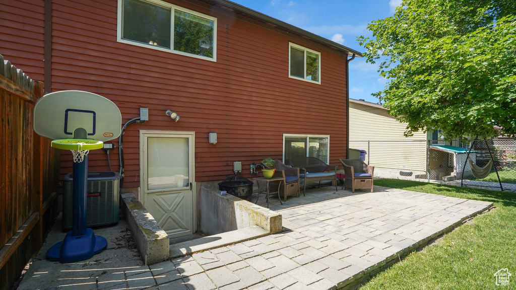 Back of property featuring cooling unit and a patio area