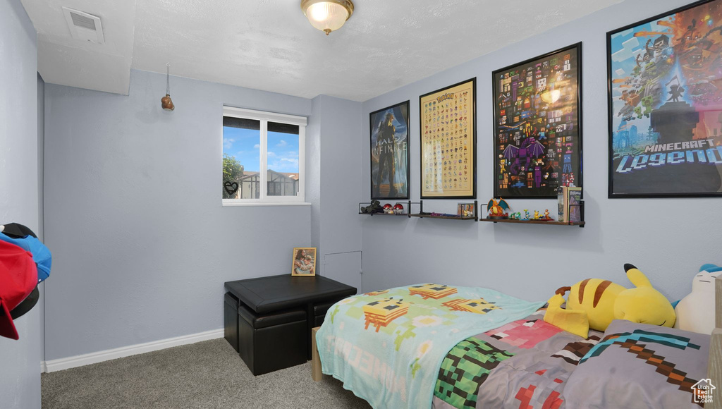 Bedroom featuring carpet flooring and baseboards