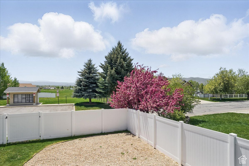 Fenced yard featuring a mountain view