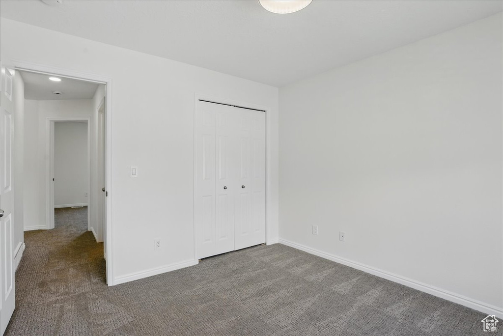 Unfurnished bedroom featuring carpet flooring and baseboards
